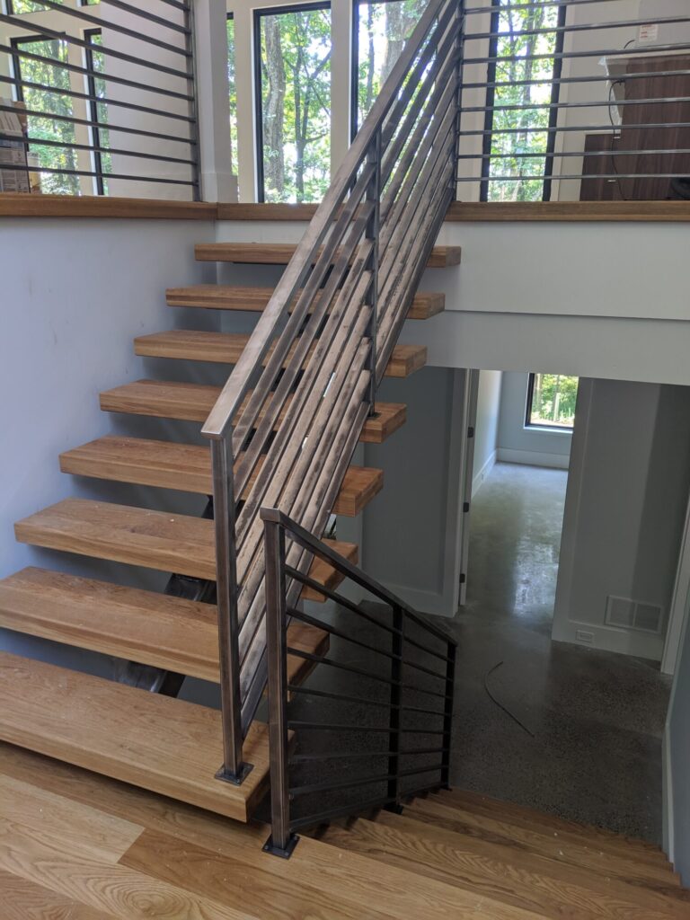 Mono stringer stair with horizontal clear coated metal rails, photo 5 of 6